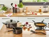 A kitchen counter with cooking utensils, pots, pans, and ingredients. Voir les images du produit