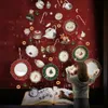 A young girl is looking at a Christmas-themed display of Villeroy & Boch tableware in a shop window. Anteprima dell’immagine prodotto