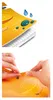 A collage of two images. The top image shows a close-up of a notebook with water droplets on it, highlighting its water-resistant feature. The bottom image shows hands peeling off a sticker from a similar notebook. Produktbild-Vorschau