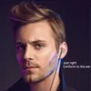A man wearing earbuds, with colored lighting. Produktbild-Vorschau