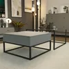 A modern living room scene featuring two coffee tables, one with a drawer and storage, and a second glass-top table. Produktbild-Vorschau