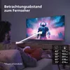 A person is sitting on a couch watching a TV, with an arrow indicating viewing distance. Náhled obrázku produktu