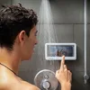A man is showering and using a waterproof phone case mounted on the shower wall. Podgląd zdjęcia produktu