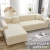 A cream-colored sectional sofa covered in a textured slipcover, with a throw pillow on each section. A small round side table with a book and cup is to the left. The sofa is placed on a rug with a geometric pattern. Text overlay promotes "THICKEN VELVET &  Náhled obrázku produktu