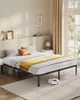 A bedroom with a bed frame, mattress, bedding, and a robot vacuum cleaner. Produktbild-Vorschau