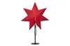 A red star-shaped lamp on a black stand against a white background. Podgląd zdjęcia produktu