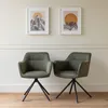 Two green fabric chairs with black metal bases are shown in a room with light-colored walls and framed artwork above. Produktbild-Vorschau