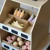 A wooden market stand filled with toy fruits and vegetables. Produktbild-Vorschau