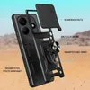 A disassembled view of a black phone case with labels pointing out its features, set against a desert-like background with a light blue sky. Produktbild-Vorschau