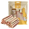 A bag of dog treats with some treats spilled in front of it. Podgląd zdjęcia produktu