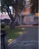 An outdoor pathway leading to a grand building at dusk, illuminated by pathway lights. Voir les images du produit