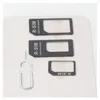 A set of SIM card adapters and a SIM ejector tool laid out on a light gray surface. Podgląd zdjęcia produktu