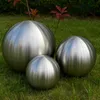 Three metallic spheres of varying sizes are placed on a grassy lawn. Podgląd zdjęcia produktu