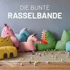 A collection of colorful animal-shaped beanbag chairs for children, with small balls scattered on the floor. Podgląd zdjęcia produktu