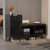 A black shoe cabinet with a bench and gold accents, placed in a hallway. Podgląd zdjęcia produktu