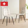 Two beige upholstered dining chairs with black metal legs are shown in a well-lit room. Náhled obrázku produktu