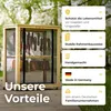 A wooden drying cabinet with meat and sausages hanging inside, set up outdoors on a wooden deck with trees in the background. Produktbild-Vorschau