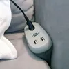 A close-up shot of a brennenstuhl sofa power outlet with USB charging ports, plugged into a sofa. Produktbild-Vorschau