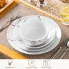 A set of white porcelain dishes with a brown swirl design is laid out on a table with a placemat, fork, and glass of water. Náhled obrázku produktu