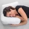 A woman is sleeping on her side with her head resting on a white pillow. Produktbild-Vorschau