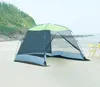 A tent on a sandy beach with the ocean and a hill in the background. Náhled obrázku produktu