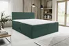A green boxspring bed with a white mattress is shown in a room with curtains and a window. Produktbild-Vorschau