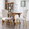 A dining room setting with a wooden table and chairs. Produktbild-Vorschau