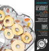 A close-up shot of a food dehydrator tray filled with dried apple slices and other dried fruits. Produktbild-Vorschau