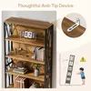 A bookshelf with decorative items and books, with an inset showing an anti-tip device and a diagram illustrating its use. Náhled obrázku produktu