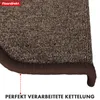 Close-up of the edge of a brown carpet stair mat, showing the stitched edge and a logo. Produktbild-Vorschau