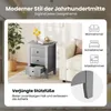 A gray nightstand with three drawers is shown next to a cream-colored sofa, with decorative items on top of the nightstand. Text overlays describe the product's style and features. Podgląd zdjęcia produktu