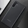 A black Samsung Galaxy Note 10 phone case is shown on a textured black surface, next to a laptop. Produktbild-Vorschau