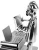 A metal figurine of an engineer working at a desk with a laptop. Produktbild-Vorschau