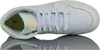 A top-down view of a white Nike Air Jordan 1 Mid sneaker, reflected on a white surface. Podgląd zdjęcia produktu