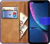 A book-style phone case for an iPhone XR, open to reveal card slots and cash, with the phone inside. Produktbild-Vorschau