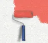 A paint roller is painting a white textured wallpaper with red paint. Produktbild-Vorschau