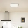 A modern kitchen with a stainless steel range hood and a ceiling light panel. Produktbild-Vorschau