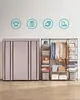 A fabric wardrobe and an open shelving unit displaying clothes and accessories against a light wall. Náhled obrázku produktu