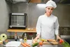 A female chef in a kitchen with ingredients on a counter. Produktbild-Vorschau