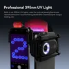 A smartphone with an attached APEXEL lens attachment is shown, with a UV light illuminating a pattern on the phone screen and a label with Chinese text. Produktbild-Vorschau