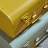 Close-up view of two metal storage boxes, one yellow and one gray, stacked on top of each other. Podgląd zdjęcia produktu