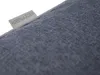 A close-up shot of a grey fabric cushion with a label attached. Náhled obrázku produktu