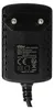 A close-up view of the back of a black AC/DC adapter with text and symbols visible. Produktbild-Vorschau