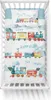 A baby crib with bedding featuring a toy train theme. Produktbild-Vorschau