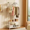 A white garment rack with clothes and storage boxes, placed in a room with curtains and a window. Anteprima dell’immagine prodotto