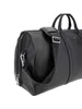 A close-up, studio shot of a black duffel bag. Produktbild-Vorschau
