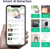 A hand holding a smartphone displaying a security camera app with various AI detection features illustrated on the side. Produktbild-Vorschau