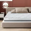 A mattress on a bed frame with pillows. Voir les images du produit