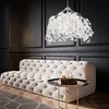 A luxurious living room scene featuring a tufted sofa and a decorative pendant lamp. Produktbild-Vorschau