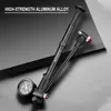 A black bicycle shock pump with a pressure gauge is displayed on a dark, angled surface. Produktbild-Vorschau